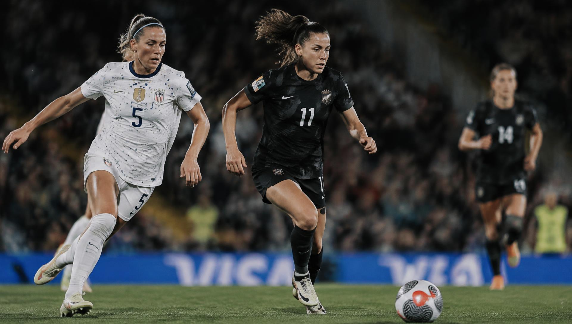 Women's professional soccer match under stadium floodlights